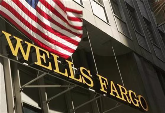 A U.S. flag flies above Wells Fargo & Co headquarters in San Francisco
