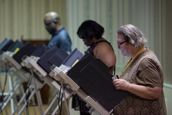 Image: Voters cast electronic ballots during primary voting in Stark County