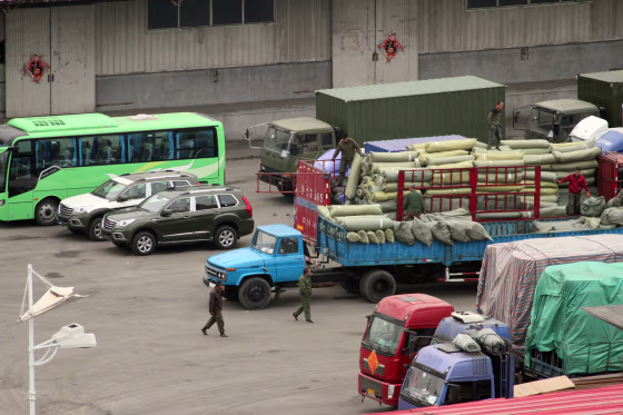 Image: Cargo trucks and other vehicles wait at a border checkpoint to cross into North Korea in Dandong