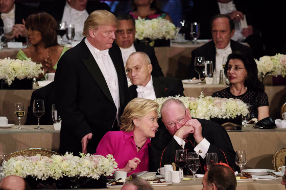 Image: Trump pats Clinton on the back at the Al Smith dinner