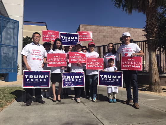 Volunteers with Chinese Americans for Trump with signs.