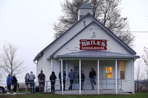 Image: Voters wait in line outside a polling location for the 2016 US presidential election before the polls open at Briles Schoolhouse in Peoria Township near Ottawa, Kansas