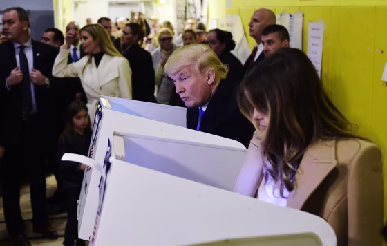 Image: Trump and his wife Melania fill out their ballots at a polling station