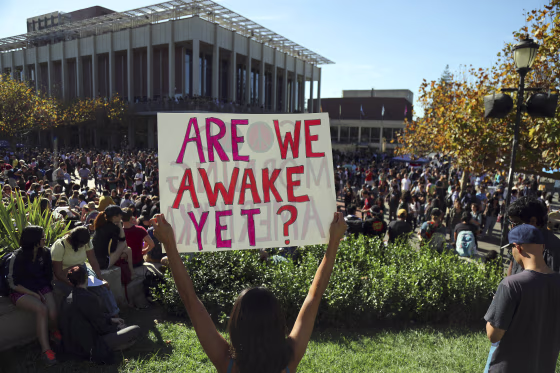 Image: Cristina Levert protests the election of Donald Trump with a mixed group of students from Berkeley High School and University of California, Berkeley, at Sproul Plaza on the university's campus in Berkeley, Calif.