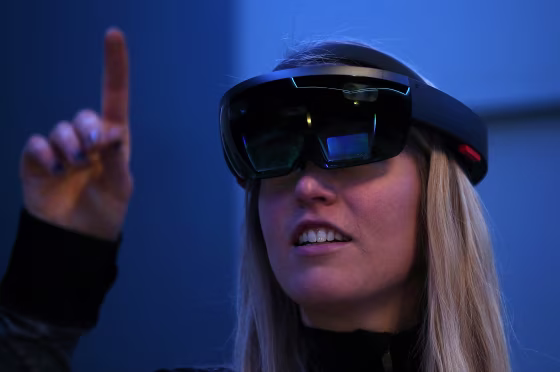 Image: A Microsoft employee demonstrates the Microsoft HoloLens augmented reality (AR) viewer