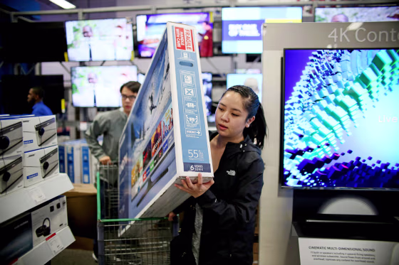 Image: Shoppers buy electronic items during Black Friday sales