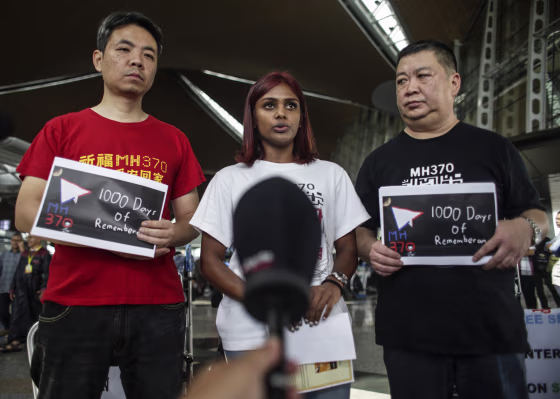 Image: MH370 relatives Grace Subathirai Nathan of Malaysia stands between and Jiang Hui (left) and Bai Shuan Fu (right) from China at Kuala Lumpur International Airport before their trip to Magadascar.
