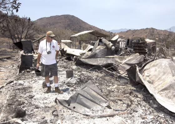 Steve Keeling walks through the ashes of his fire ravaged home, Monday, June 27, 2016, in South Lake, Calif. The home was one of the homes and structures that were destroyed by the fire that started Thursday, near Lake Isabella, Calif.