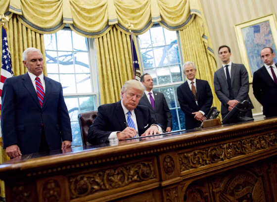 Image: Trump signs an executive order in the Oval Office