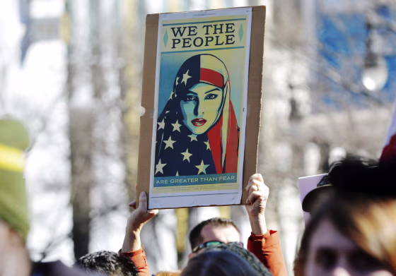 Image: Hundreds of people gathered in downtown Durham to show their support for refugees and immigrants and stand against President Donald Trump's plan to ban refugees of Muslim countries on Jan. 27 in Durham, North Carolina.