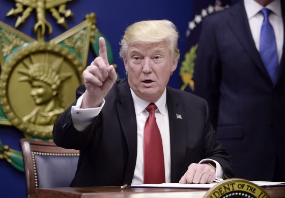 Image: US President Donald Trump signs Executive Orders at the Pentagon in Arlington, Virginia