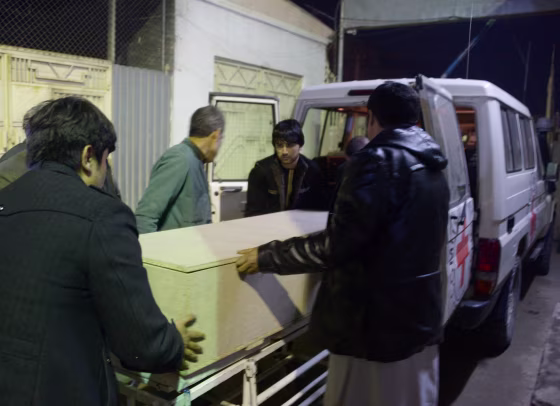 Image: Afghan men unload a coffin of an International Committee of the Red Cross (ICRC) employee, who was killed by gunmen in Jwzjan province, at a hospital in Mazar-i-Sharif, Afghanistan on Feb. 8.