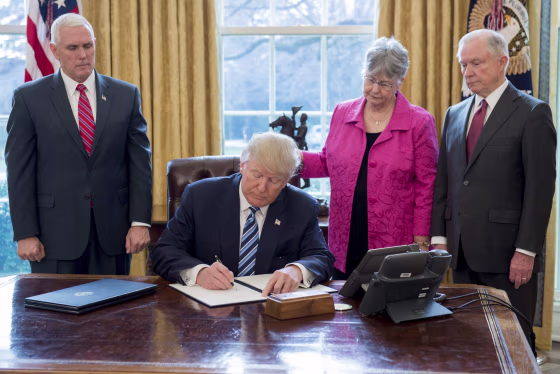 Image: President Donald Trump signs an executive order related to to crime