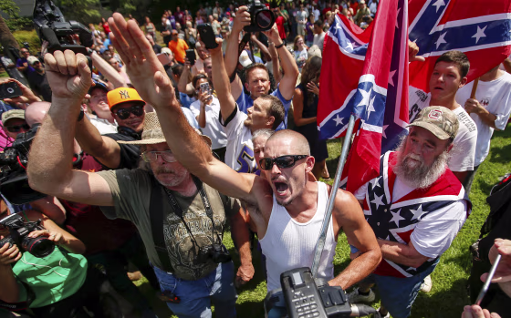 Image: A supporter for the Ku Klux Klan and the Confederate flag yells at opposing demonstrators during a rally at the statehouse in Columbia
