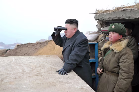 Image: Kim Jong Un uses binoculars to look at South Korean territory from an observation post on Jangjae islet