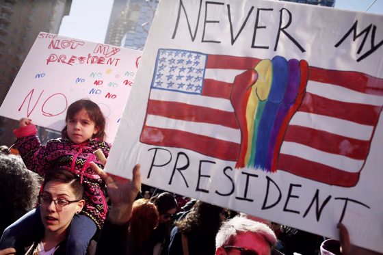 Image: People hold signs at a rally in New York, Feb. 20, 2017.