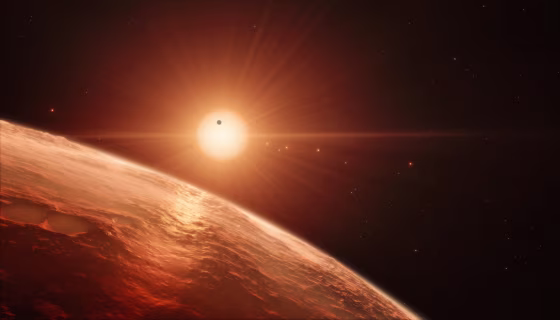 Image: This artist's impression shows the view from the surface of one of the planets in the TRAPPIST-1 system.