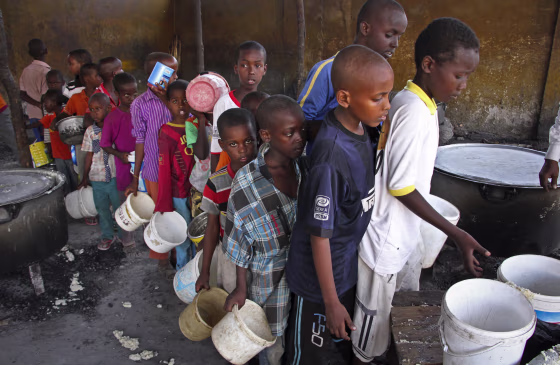 Image: Displaced Somali boys who fled the drought in southern Somalia stand in a queue to receive food handouts at a feeding center in a camp in Mogadishu, Somalia.