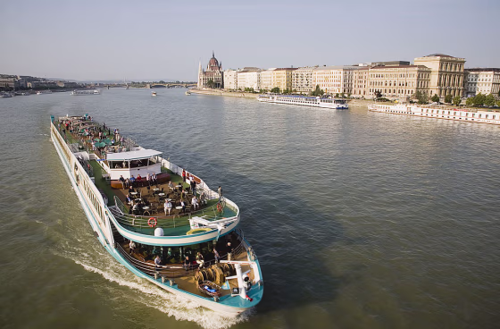 Pleasure cruise boat on the River Danube approaching Szechenyi Chain Bridge