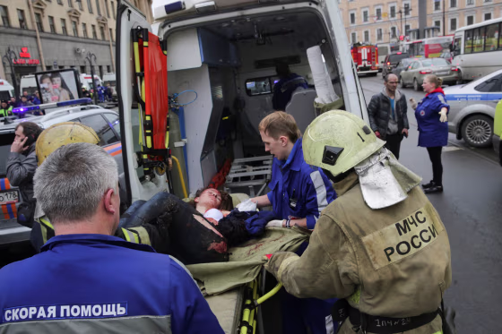 Image: An injured person is helped by emergency services outside Sennaya Ploshchad metro station following explosions in St. Petersburg