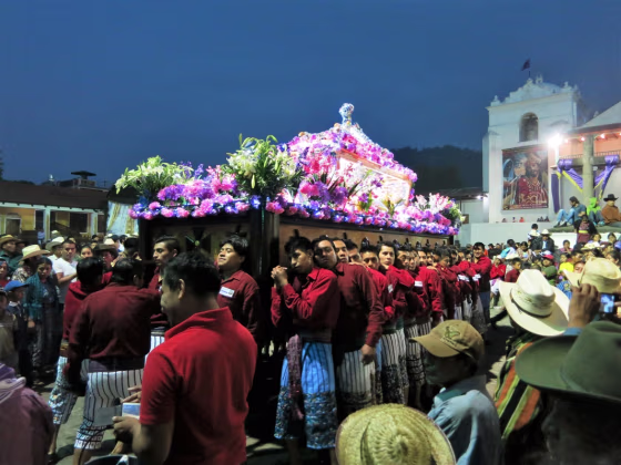 El Señor Sepultado—the statue of the buried Christ— is carried on a wooden platform by the village men in the traditional dress of Santiago Atitlan.