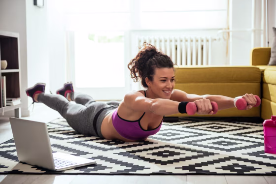 Image: Woman working out at home with computer