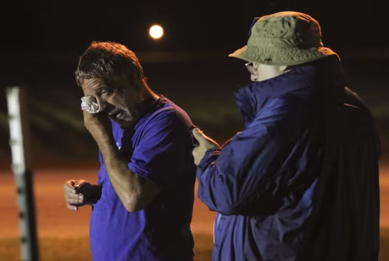 Image: Anti-death penalty supporter Randy Gardner, left, wipes away a tear moments after Abraham Bonowitz, left, reads on his phone the 11:45pm Supreme Court decision to halt the execution
