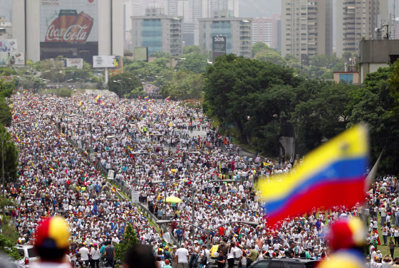 Image: Demonstrators clash with riot police during the so-called \"mother of all marches\" against Venezuela's President Maduro in Caracas