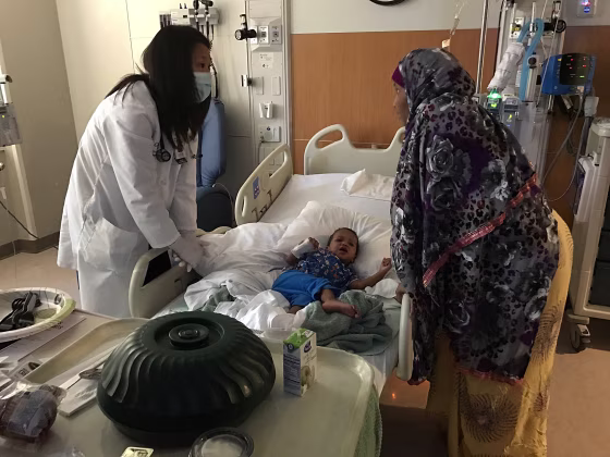 Image: Mahat Issa, age 3, lies in a hospital bed in Children's Minnesota hospital
