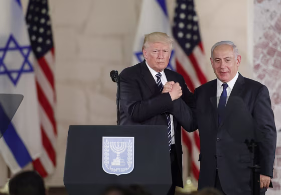 Image: Trump and Netanyahu clasp hands