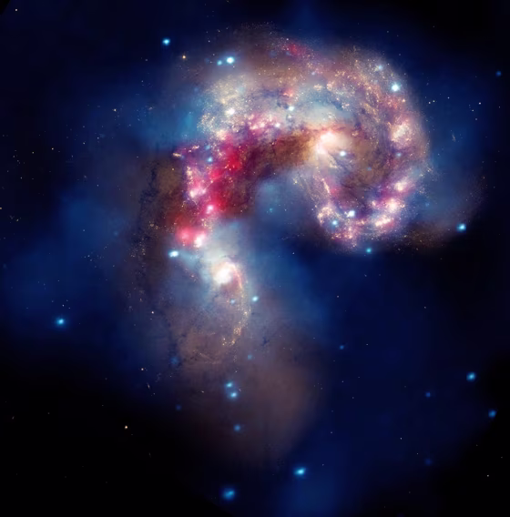 This beautiful new composite image of two colliding galaxies was released by NASA's Great Observatories. The collision between the Antennae galaxies, which are located about 62 million light-years from Earth, began more than 100 million years ago and is still occurring.