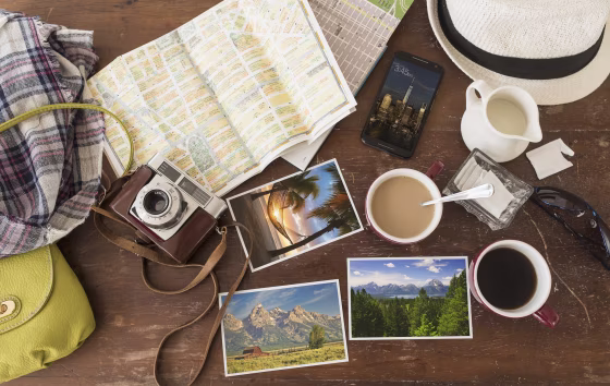 Image: Maps, photographs, a camera and cell phone sit on a table