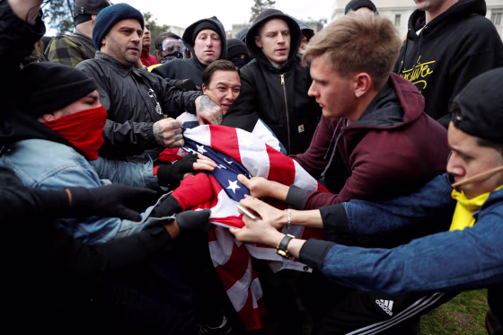 Counter-demonstrators (L) and supporters (R) of U.S. President Donald Trump fight for a U.S. flag during a \"People 4 Trump\" rally in Berkeley, California