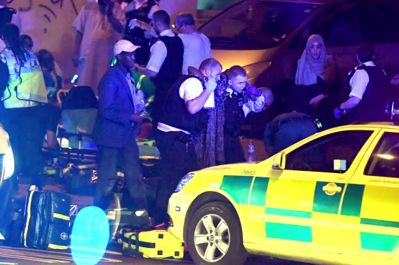 Image: Police and ambulance crews assist an injured pedestrian at the scene of the attack near Finsbury Park