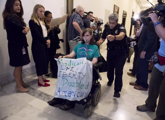 Image: U.S. Capitol Police remove a protester outside the office of Senate Majority Leader Mitch McConnell