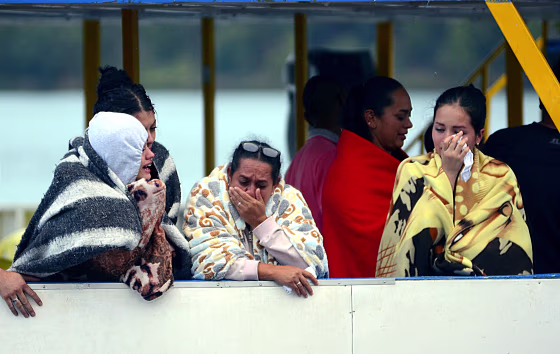 IMAGE: Onlookers wait for information in Colombia