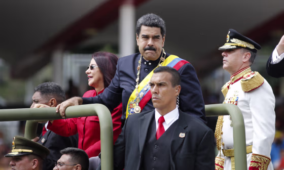 Venezuela's President Nicolas Maduro and first lady Cilia Flores ride in a vehicle during a military parade commemorating the country's Independence Day in Caracas, Venezuela, Wednesday, July 5, 2017.