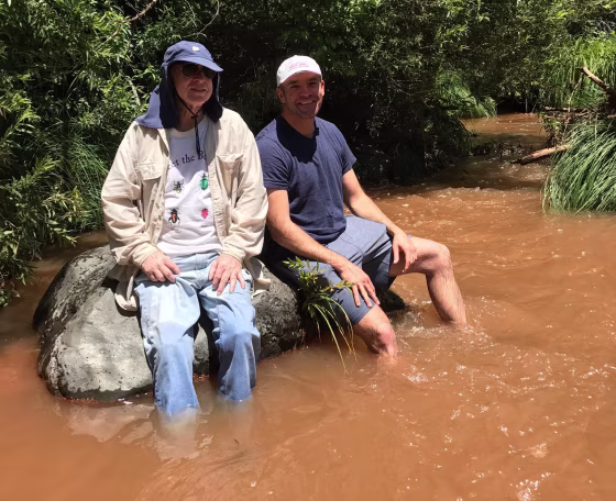 Image: John McCain and Joe Harper sit on a rock at Zebra Falls