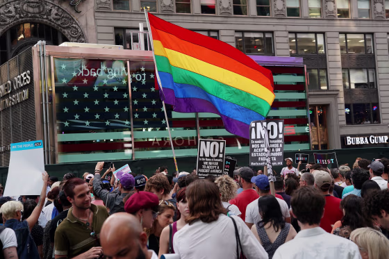 Image: A rainbow flag flies as people protest U.S. President Donald Trump's ban on transgender individuals in the U.S. military
