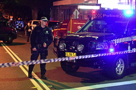 Image: Police man a check point in the Sydney inner suburb of Surry Hills