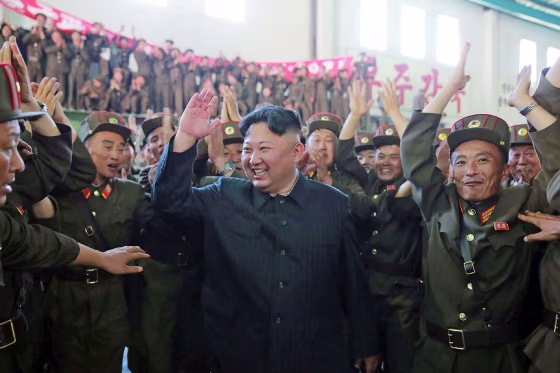 Image: North Korean leader Kim Jong-Un (C) celebrating the successful test-fire of the intercontinental ballistic missile
