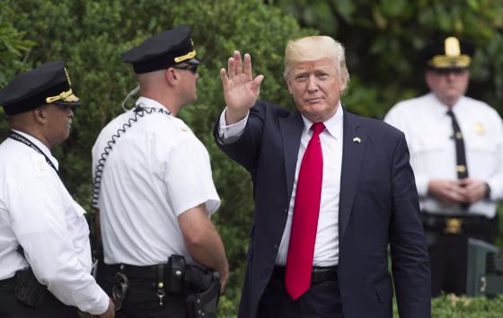 Image: President Donald Trump, surrounded by Uniformed Division Secret Service officers, arrives on the South Lawn of the White House