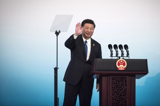 Image: China's President Xi Jinping waves during a press conference