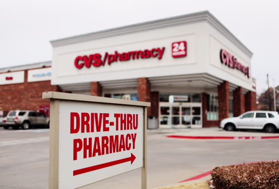 Image: A \"Drive-Thru Pharmacy\" sign is displayed outside of a CVS Caremark Corp. store