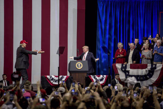 Image: President Donald Trump greets Strange on stage after speaking to supporters.