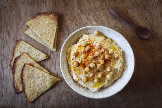 Bowl of Hummus and flat bread on wood