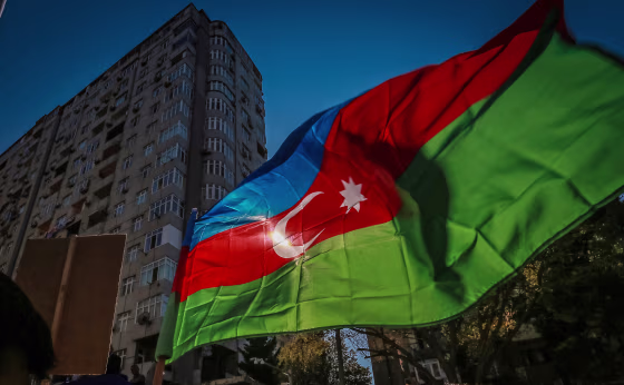 Azerbaijani opposition supporters holds an Azerbaijan flag
