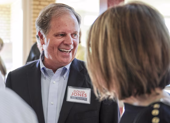 Image: Candidate Doug Jones chats with constituents