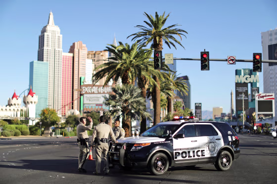 Image: Police stand in front of the closed Las Vegas Strip next to the site of the Route 91 music festival mass shooting outside the Mandalay Bay Resort and Casino in Las Vegas