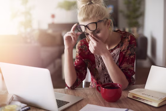 Image: A woman sits at her desk